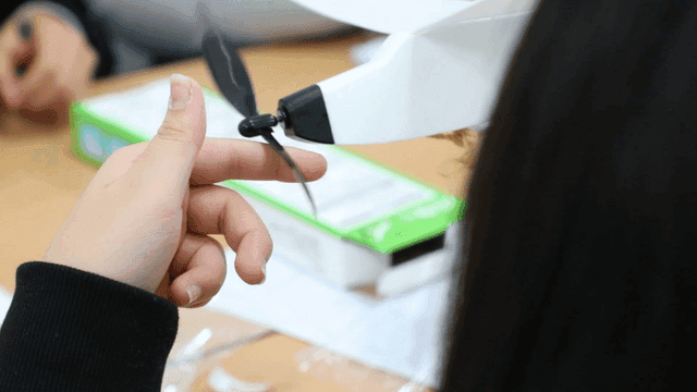 Student examining a small model airplane