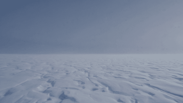 Vast snow-covered landscape under clear sky
