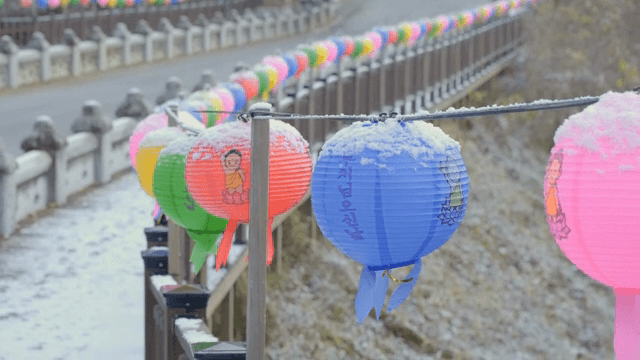 Snow-covered lanterns on a bridge