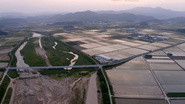 Expansive farmland with a winding river