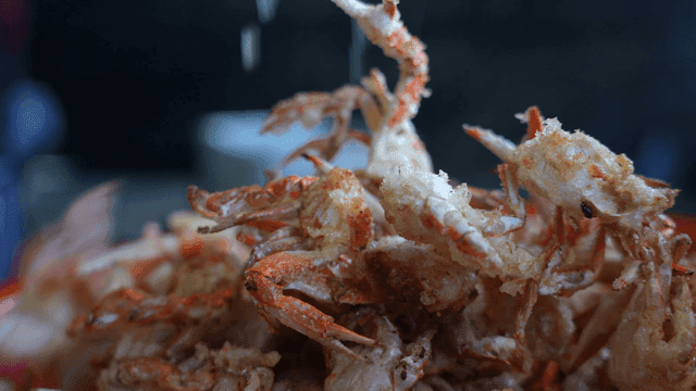 Freshly fried crabs being prepared