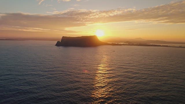 Sunset over the ocean with distant islands