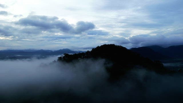 Misty mountains under a cloudy sky