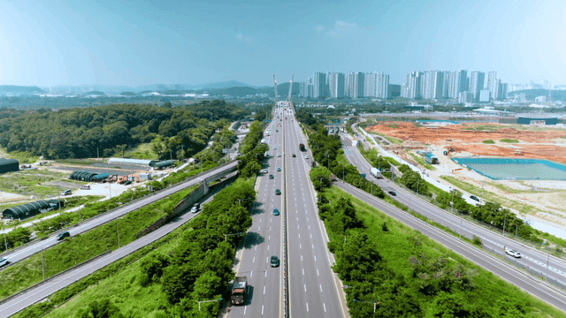Highway surrounded by greenery and urban landscapes