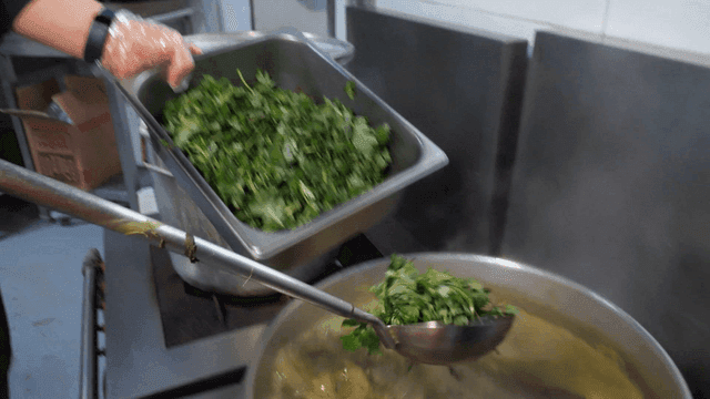 Dodari mugwort soup with fresh mugwort added to boiling pot