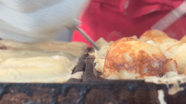 Cooking octopus balls on a hot griddle