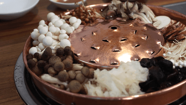 Various mushrooms arranged in a hot pot
