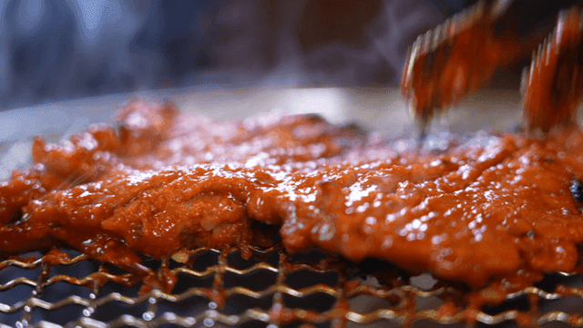 Grilled marinated meat on a barbecue grill