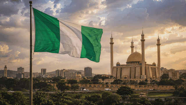 City landscape featuring prominent mosque and Nigerian flag