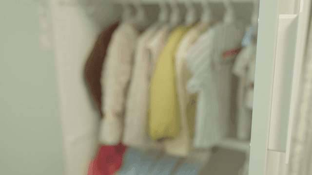 Children's clothes hanging in closet