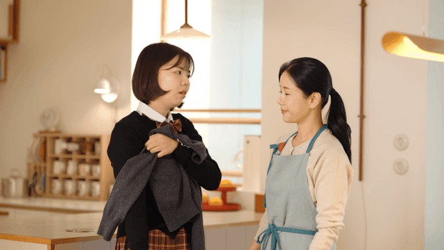 High school daughter complains to her mother at home about her clothes shrinking.