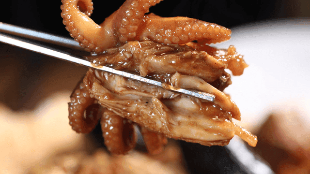 Braised chicken with baby octopus picked up with chopsticks