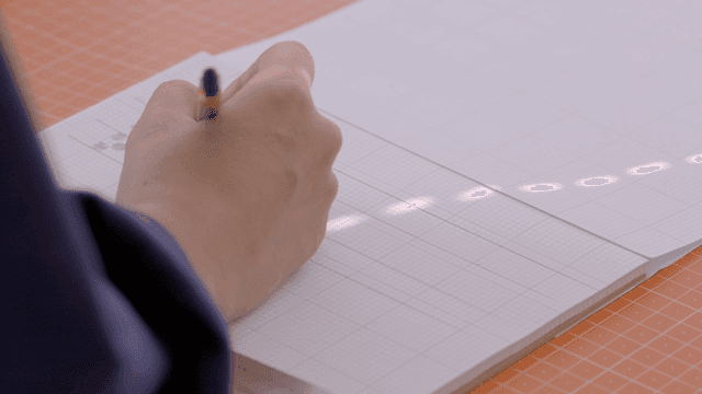 Hands drawing on paper