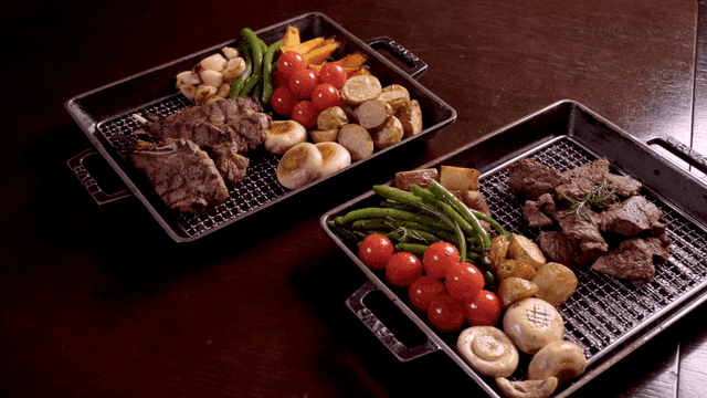 Grilled lamb ribs and beef steak on platter