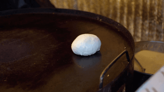 Hotteok dough placed on hot iron plate