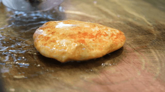 Hotteok cooked on hot iron plate