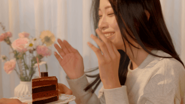 Young girlfriend blowing cake candles with happiness