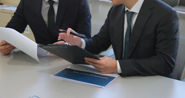 Businessmen Reviewing Documents in the Office