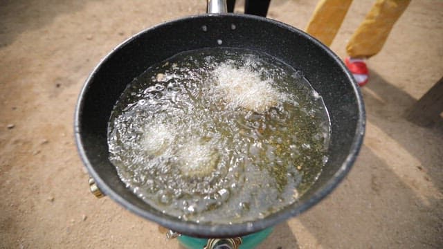 Milk fritters fried in boiling oil in a pan