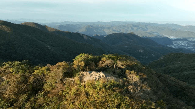 Green mountains under a clear sky