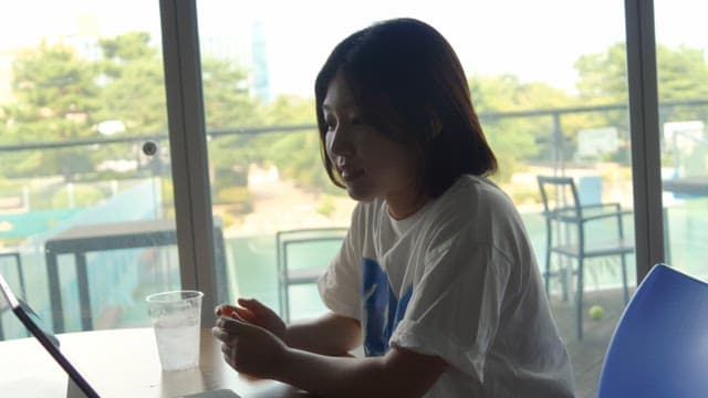 Woman having a video conference at a cafe