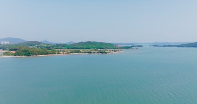 Tranquil coastal landscape with distant mountains