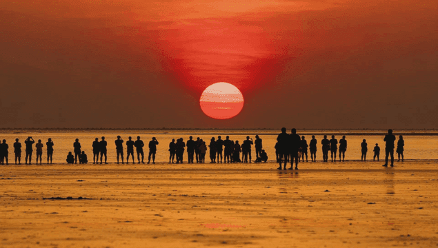 People watching a sunrise on the beach