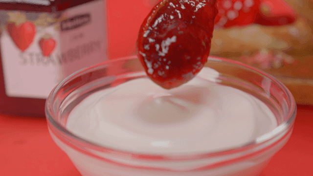 Strawberry jam and yogurt in a bowl