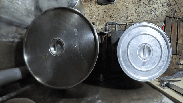 Large pots steaming in a kitchen