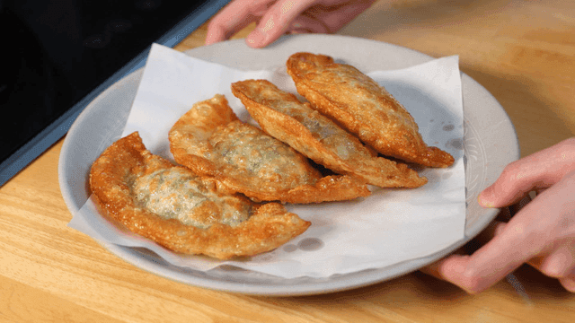 Plate of fried dumplings on table