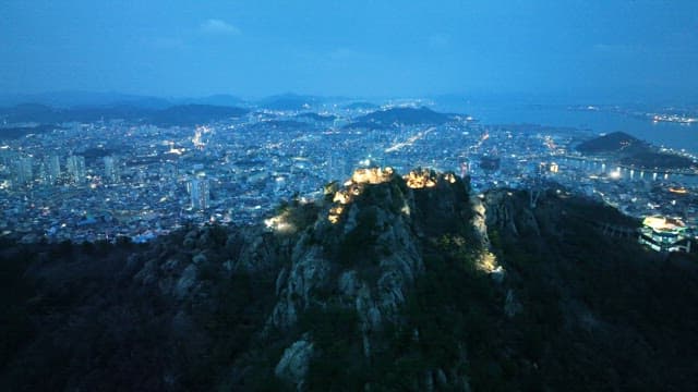 Cityscape with illuminated mountains