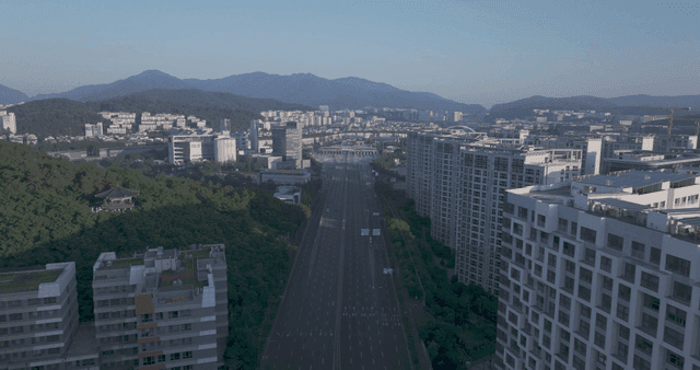 City road scenery with mountains in background