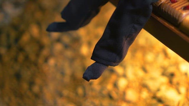 Hands dressing a small model figure