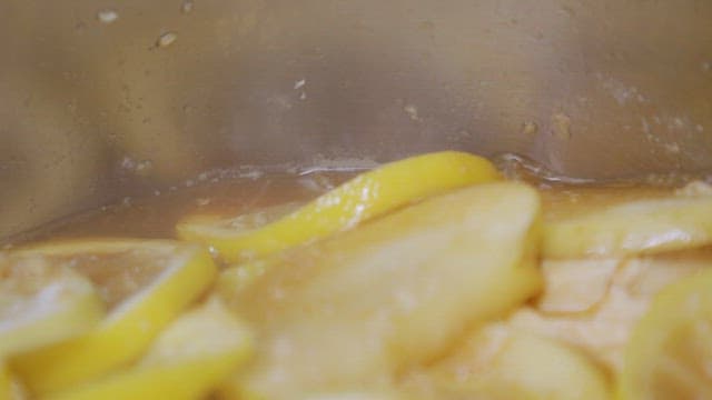 Lemon slices simmering in a pot