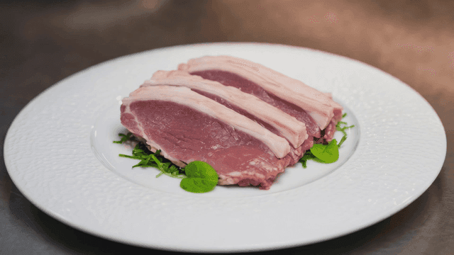 Raw pork slices on a white plate