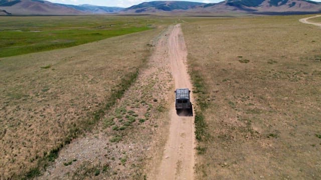 Off-road vehicle traversing a vast landscape