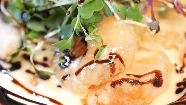 Fresh sprouts on creamy shrimp sauce