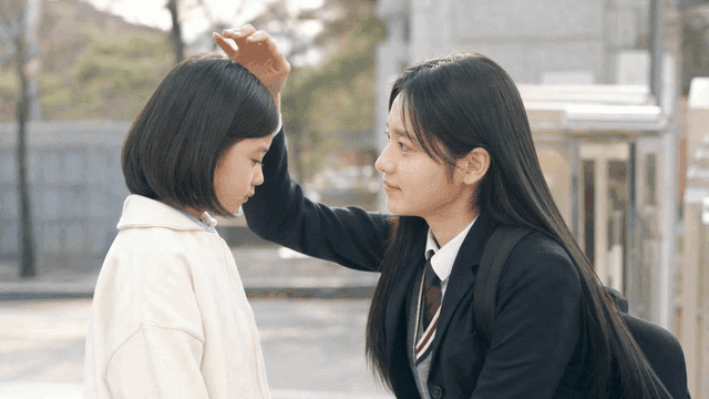 High school older sister comforting her younger sister