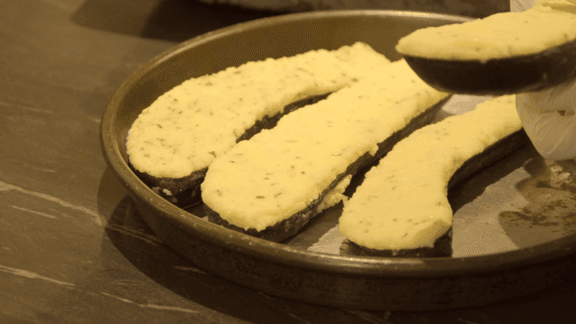 Tray of eggplant topped with cheese
