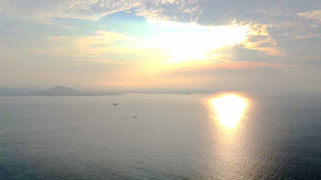 Sunlight shining through the clouds on the sea