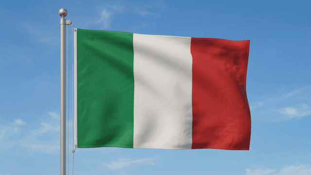 Italian flag waving against a clear sky
