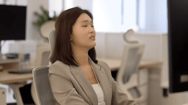 Female office worker sighing in office