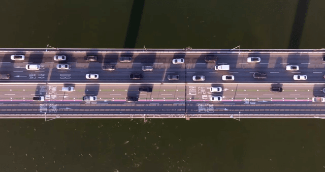 Cars moving on a bridge over a river