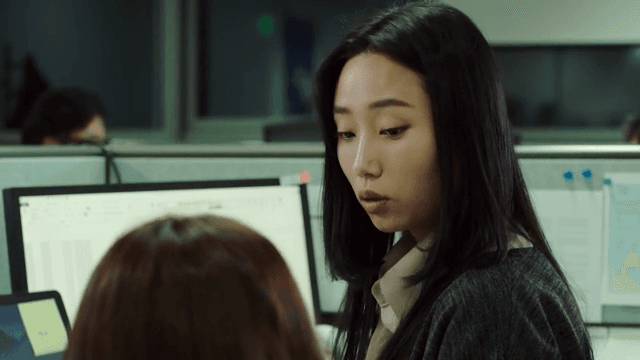 Office workers discussing at their desks