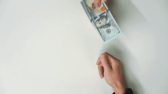 Hands exchanging currency notes