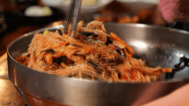 Bibim Makguksu being mixed in bowl