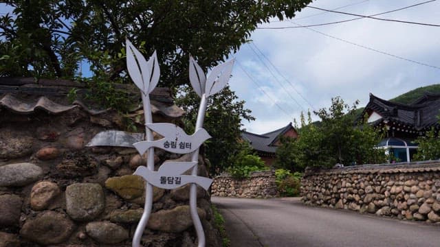 Stone path in quiet traditional village with lush greenery