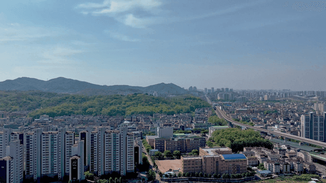 Cityscape with mountains and high-rise apartments