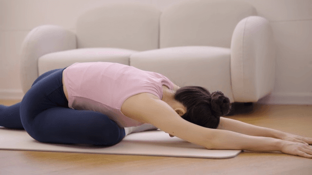 Woman stretching indoors