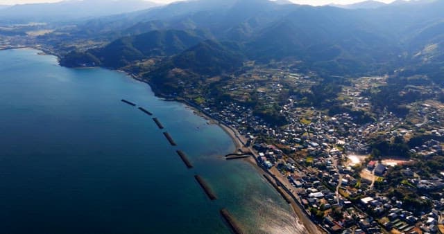 Coastal village with mountains and sea